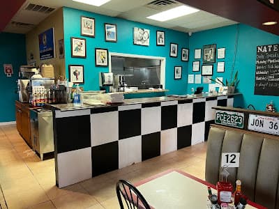The Nate's Diner counter with checker pattern and teal walls